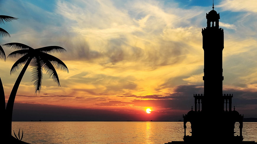 Silhouette of Clock Tower and Palm Trees at Sunset