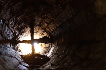 Cross Silhouette Inside Dark Wooden Mine Shaft