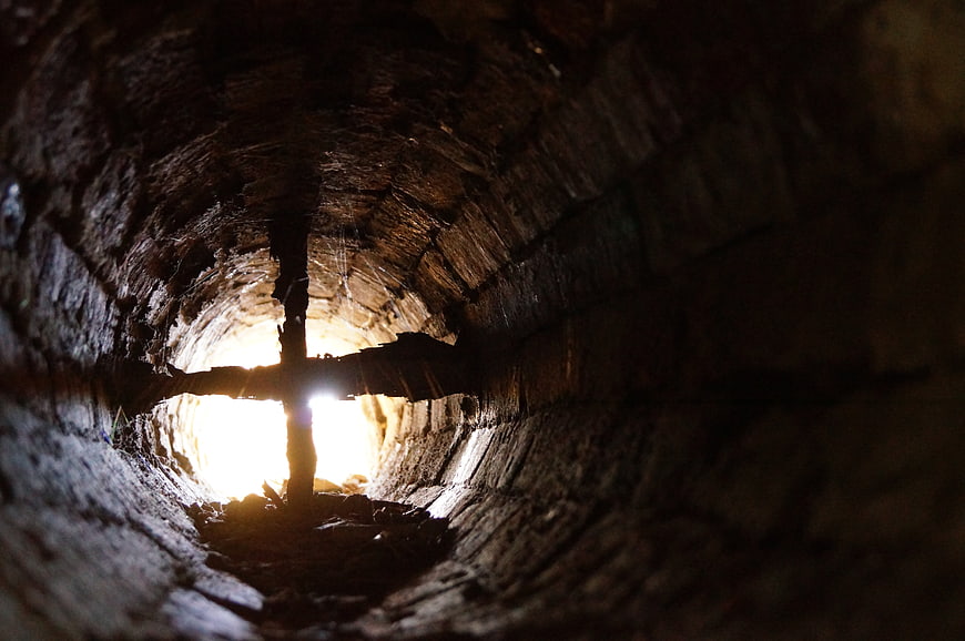Cross Silhouette Inside Dark Wooden Mine Shaft