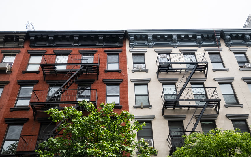 Red and White Brick Apartment Buildings with Fire Escapes