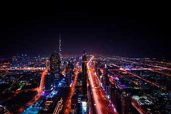 Aerial Night View of Dubai Skyline with Burj Khalifa and Light Trails