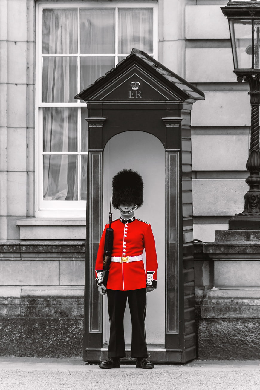 Grenadier Guard in Red Uniform Standing in Black and White Sentinal Box