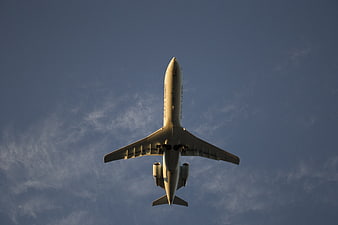Low angle view of airplane flying in blue sky