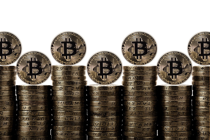 Stacks of Gold Bitcoin Coins on White Background