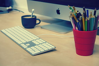 Modern Workspace with Colored Pencils and Computer