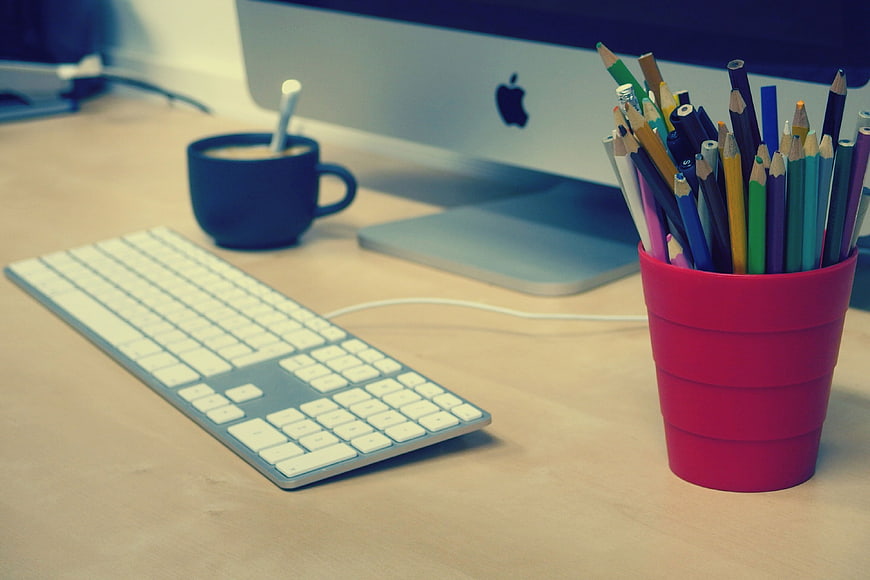 Modern Workspace with Colored Pencils and Computer