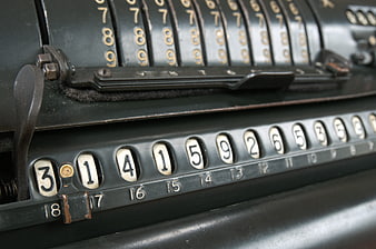 Close-up of vintage mechanical calculator with number wheels