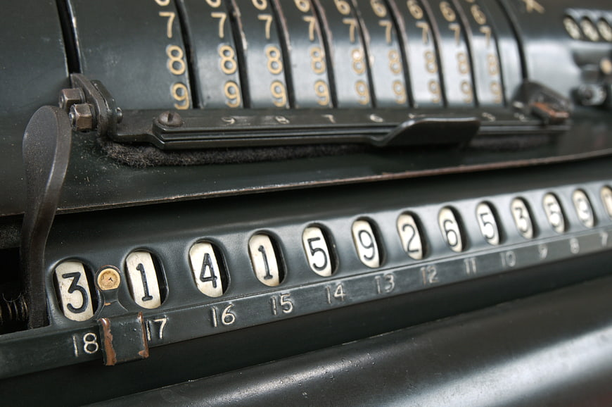Close-up of vintage mechanical calculator with number wheels