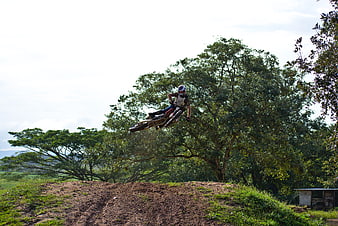Motocross Rider Jumping Dirt Bike on Outdoor Track
