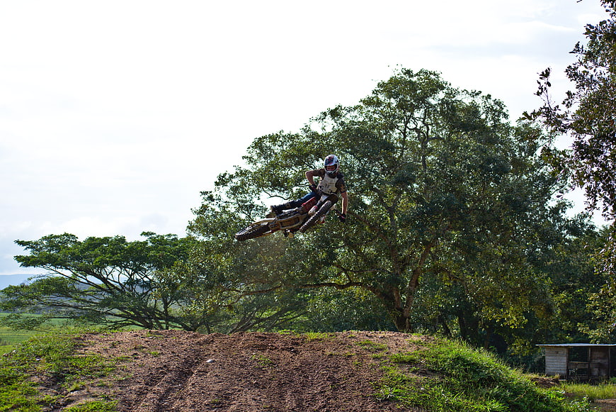 Motocross Rider Jumping Dirt Bike on Outdoor Track