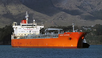 Orange Cargo Ship Garnet Express Sailing Near Mountains