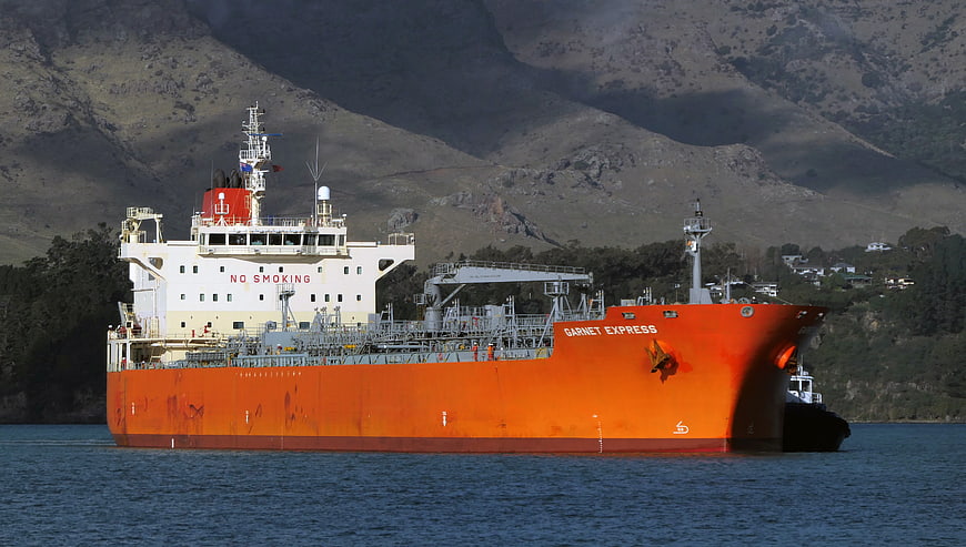Orange Cargo Ship Garnet Express Sailing Near Mountains