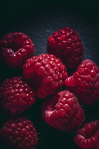 Close-up of fresh raspberries on dark background