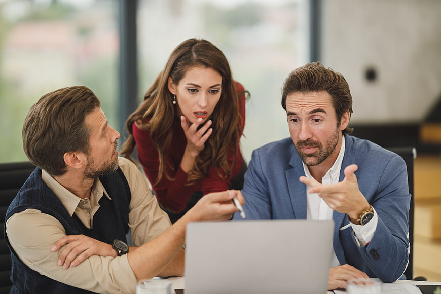 Business team discussing strategy in modern office meeting