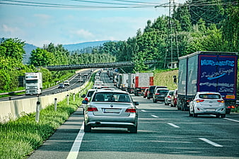Highway Traffic Jam With Cars And Trucks On A Sunny Day