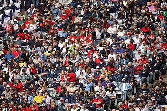 Large crowd of sports fans watching game in stadium