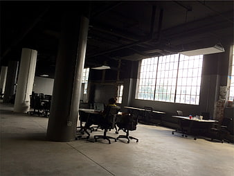 Industrial Loft Office Space with Concrete Pillars and Large Windows
