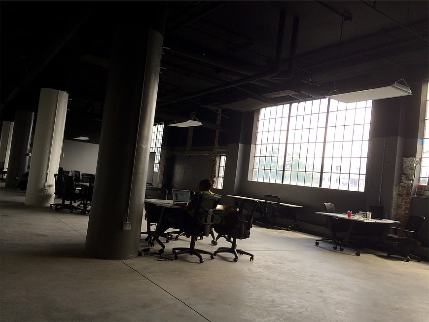 Industrial Loft Office Space with Concrete Pillars and Large Windows