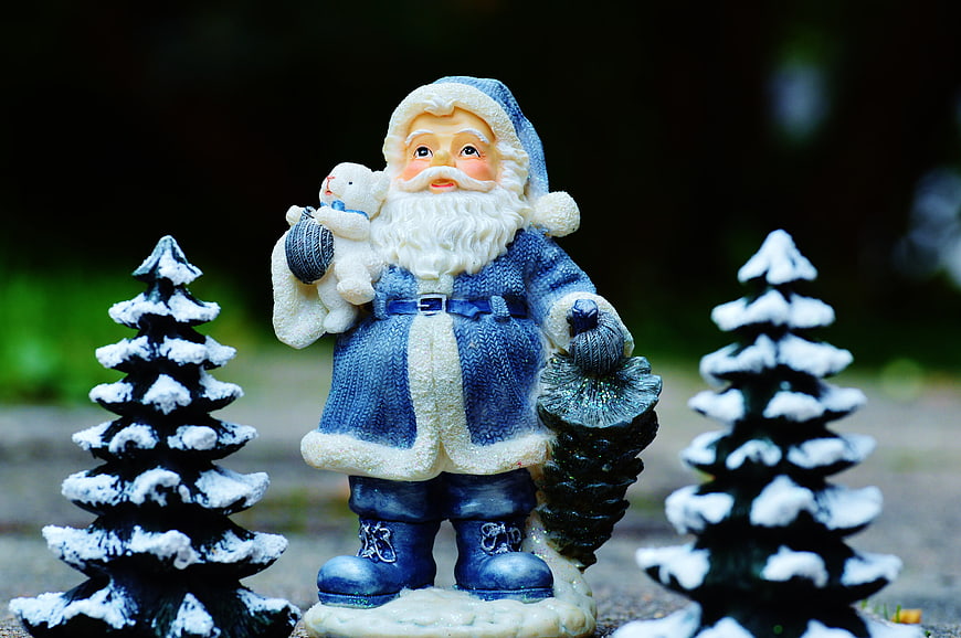 Blue Santa Claus Figurine with Teddy Bear and Snowy Trees