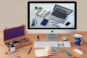 Creative workspace with iMac, color swatches, and craft tools
