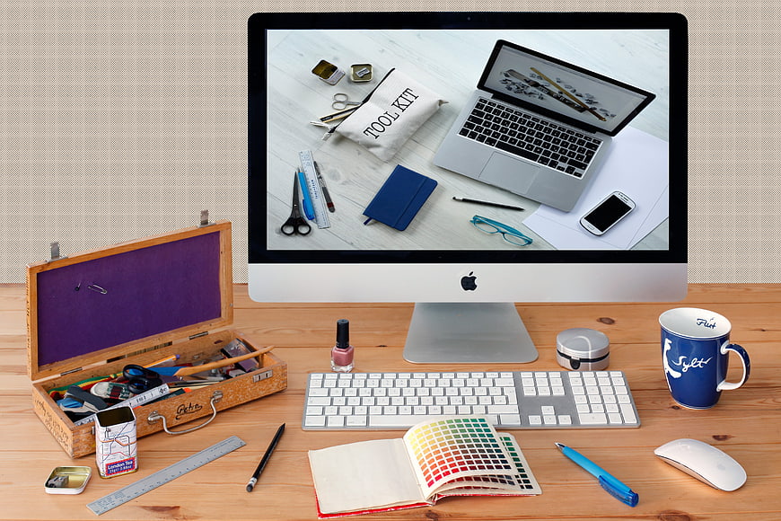 Creative workspace with iMac, color swatches, and craft tools