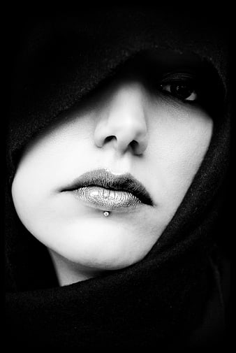Dramatic black and white portrait of woman in hood
