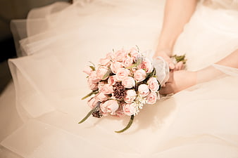 Bride Holding Soft Pink Rose Wedding Bouquet on White Tulle Veil