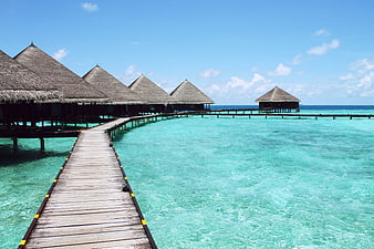 Overwater Bungalows on Wooden Pier in Turquoise Lagoon
