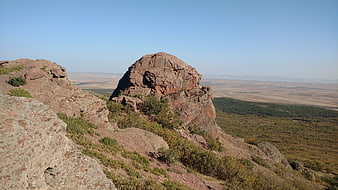 Red Rock Formation Overlooking Vast Valley Landscape