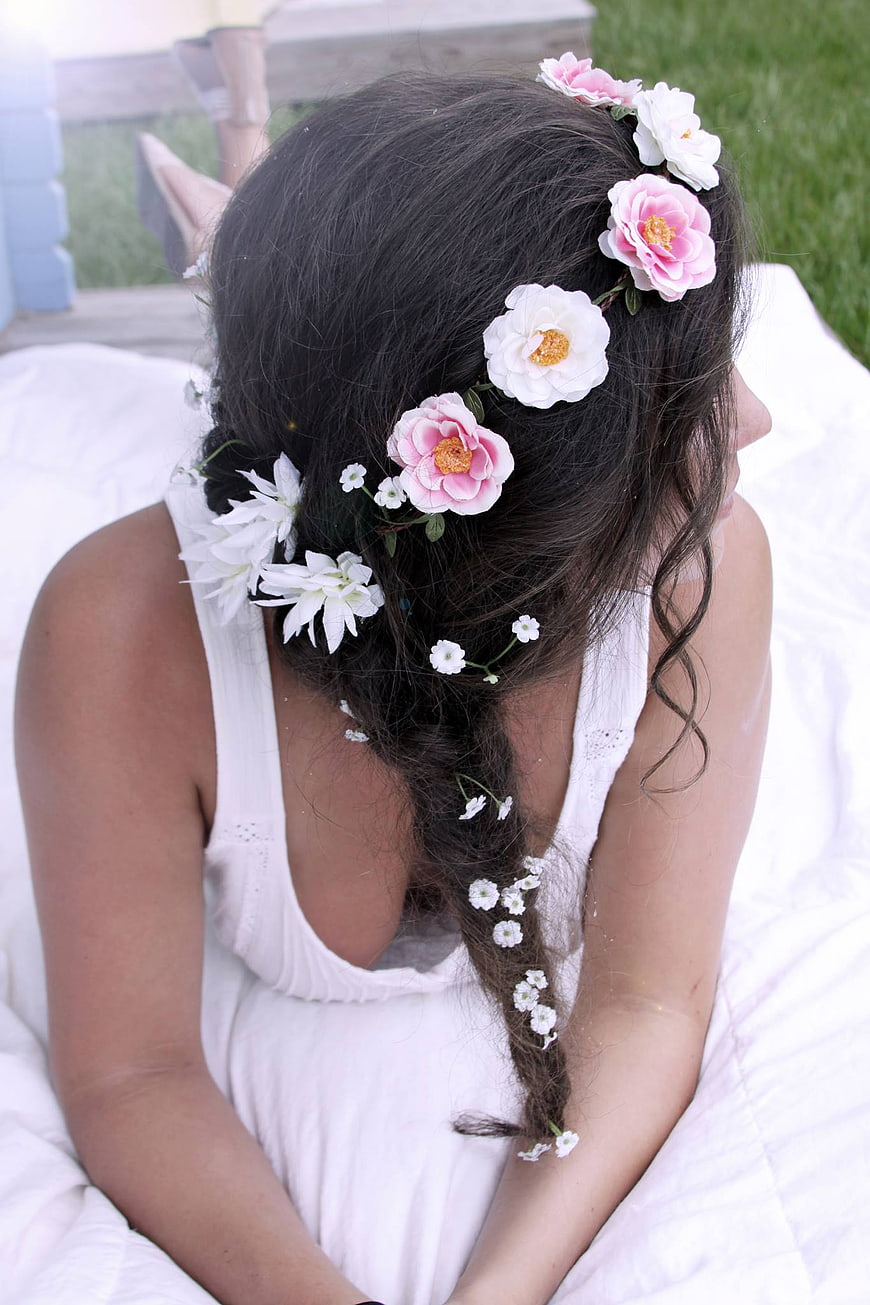 Woman with floral braided hairstyle in white dress