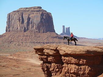 Cowboy on Horseback in Monument Valley Desert Landscape