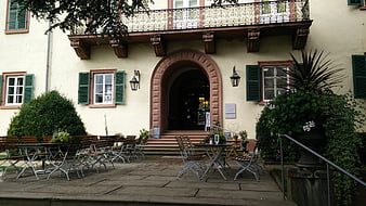 Historic European Castle Courtyard with Outdoor Cafe Seating