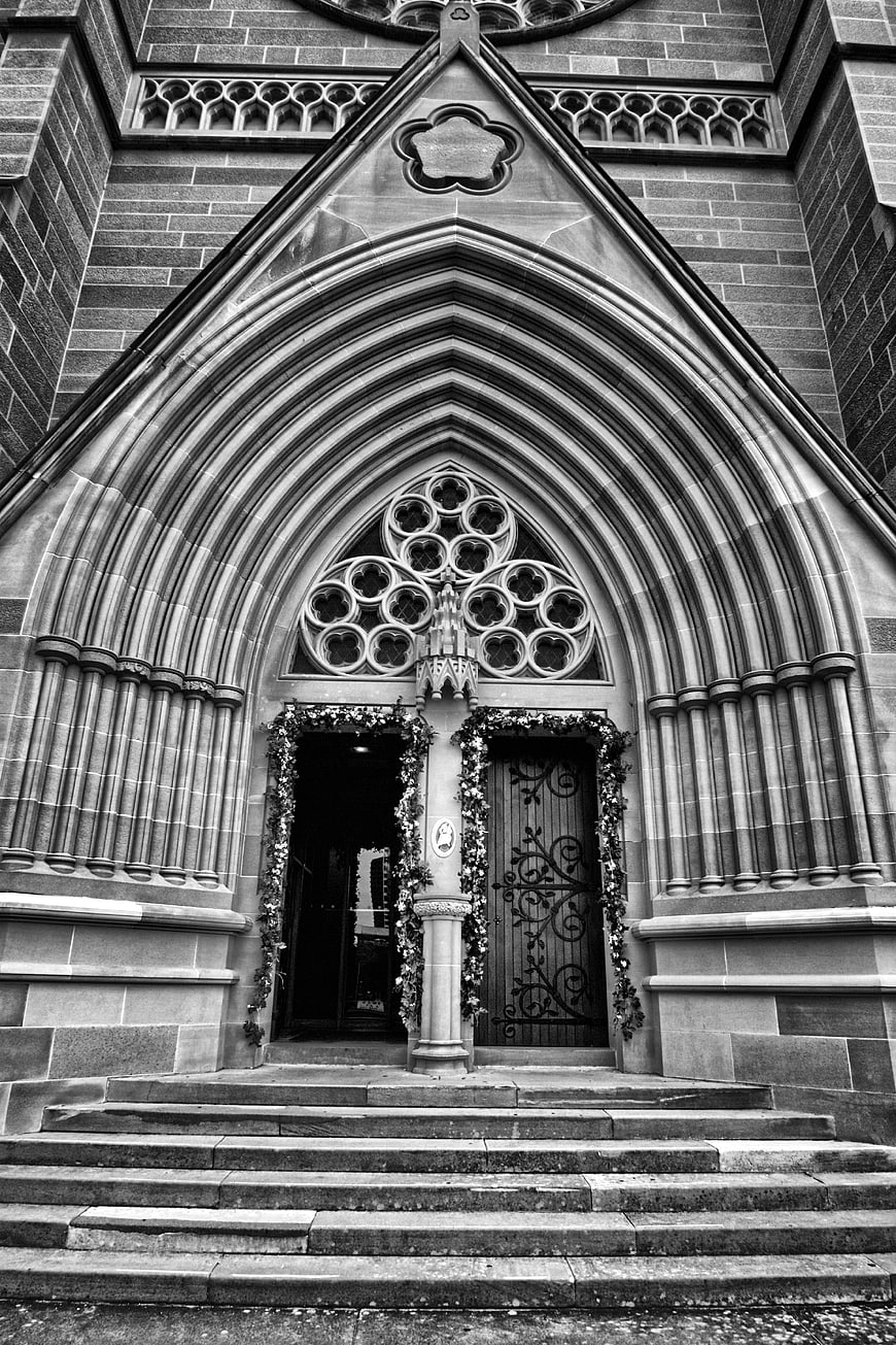 Black and white gothic church entrance with stone archway