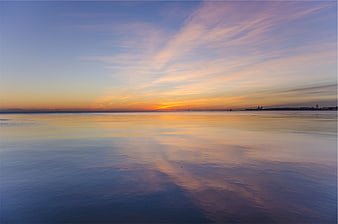 Serene Sunset Reflection on Calm Ocean Water