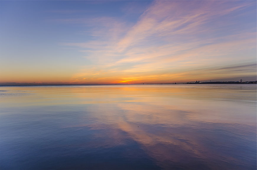 Serene Sunset Reflection on Calm Ocean Water