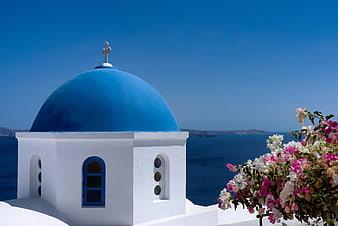 Iconic Blue Dome Church in Santorini with Bougainvillea