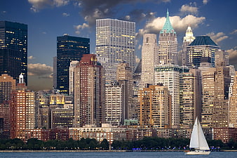 New York City Skyline at Dusk with Sailboat on Water