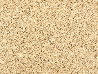 Close-up beige sand texture background with granular detail