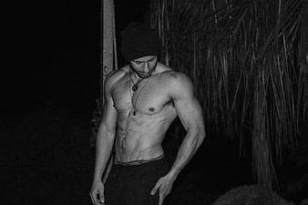 Black and white portrait of a muscular man in a beanie