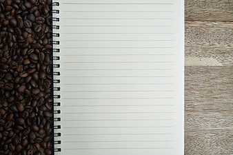 Open Notebook With Coffee Beans On Rustic Wooden Table
