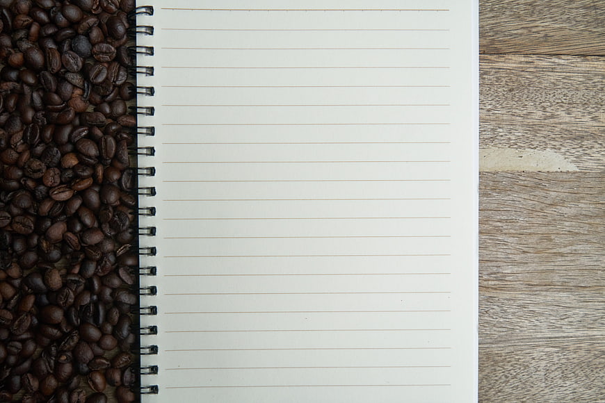 Open Notebook With Coffee Beans On Rustic Wooden Table