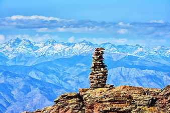 Stone Cairn on Rocky Mountain Peak with Snowy Range
