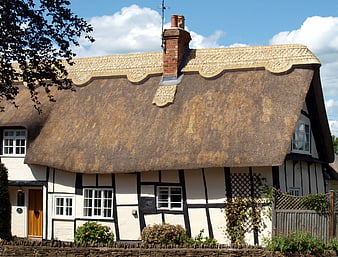 Traditional Thatched Cottage with Timber Framing and Garden