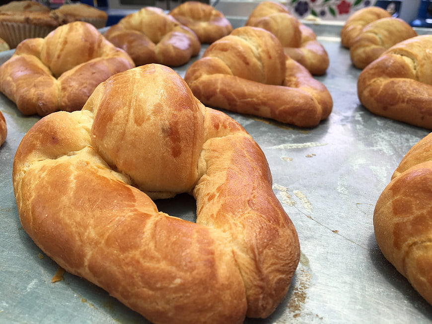 Freshly baked sweet bread rolls on metal baking tray