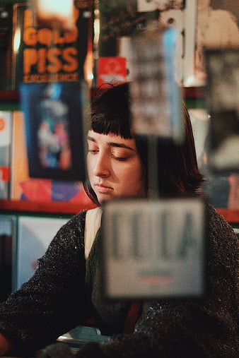 Woman browsing books in a cozy bookstore