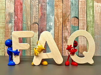 FAQ Concept With Wooden Letters And Colorful Plastic Figures