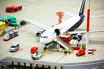 Miniature Airport Scene with Toy Airplane and Ground Vehicles