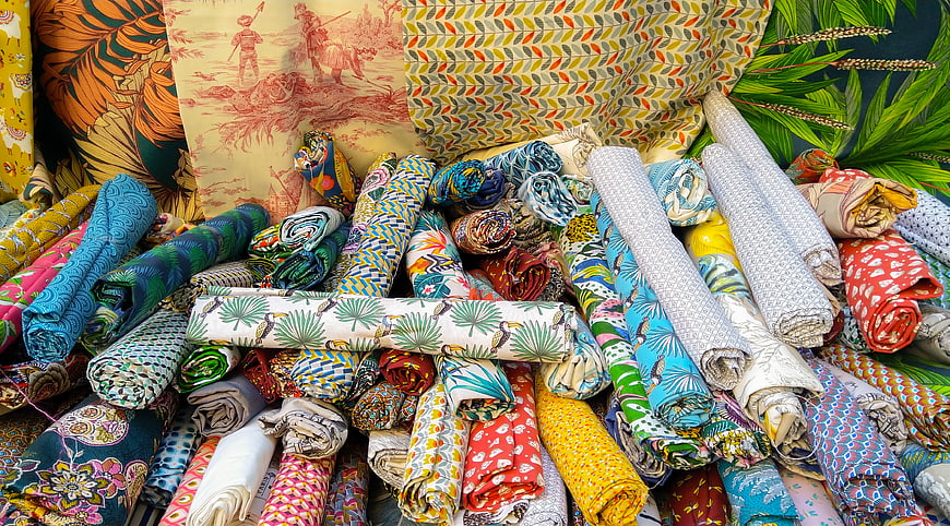 Colorful rolled fabrics with tropical and geometric patterns