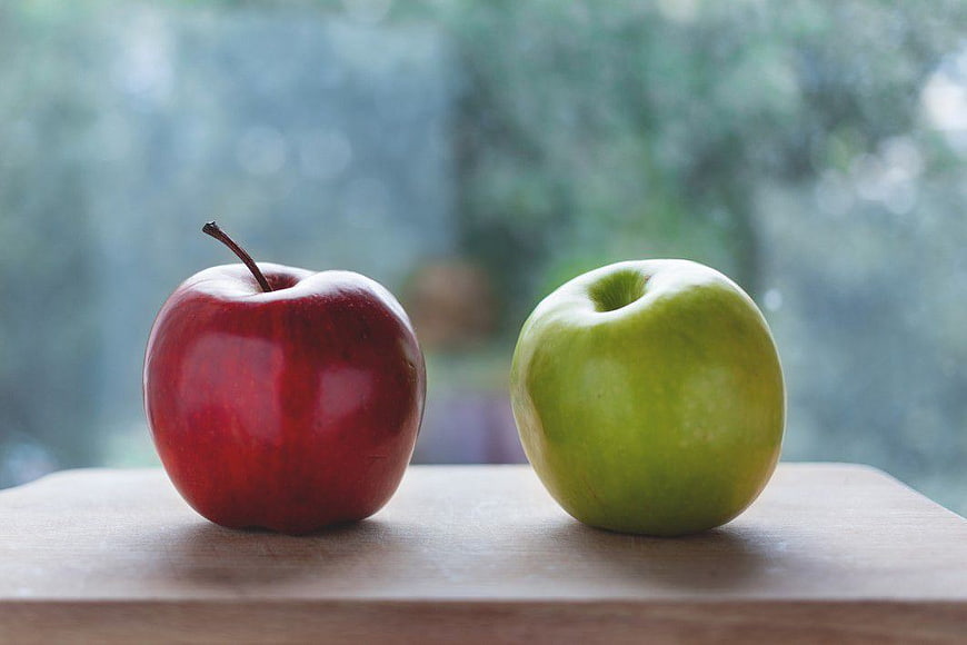 Red and Green Apples on Wooden Surface