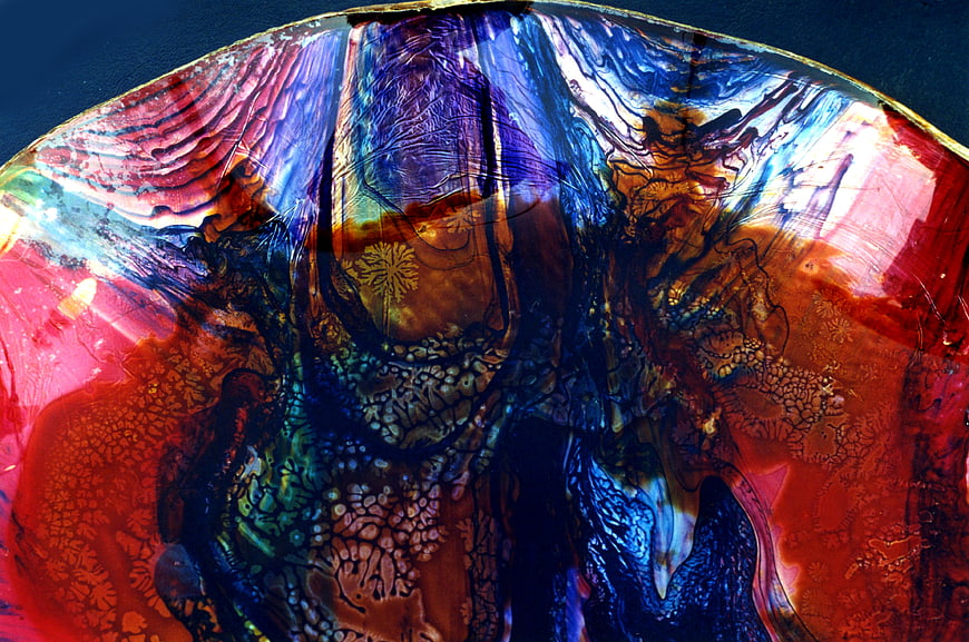 Abstract colorful glass texture with red and blue swirls